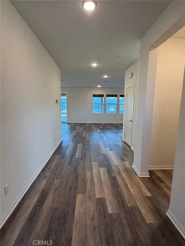 a view of a room with wooden floor and window
