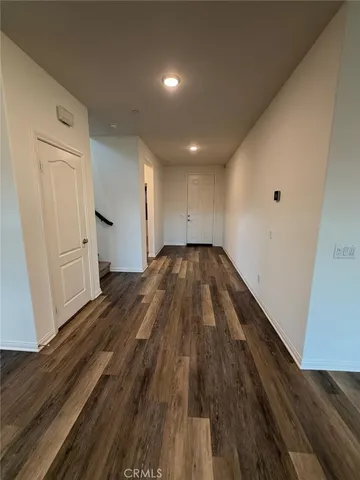 a view of a room with wooden floor