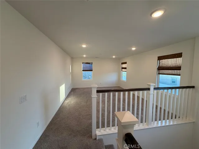 a view of a hallway with seating area