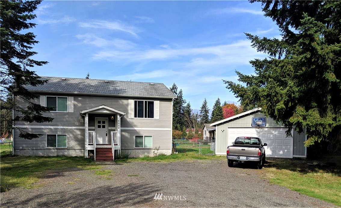 9024 176th Avenue Southwest Rochester, WA 98579 - Photo 2 of 25 a car parked in front of white house
