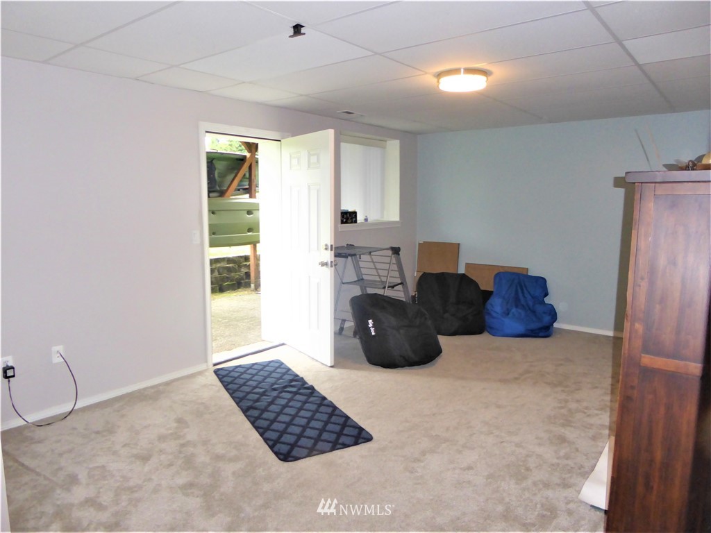 9024 176th Avenue Southwest Rochester, WA 98579 - Photo 11 of 25 a large bedroom with a bed and a window