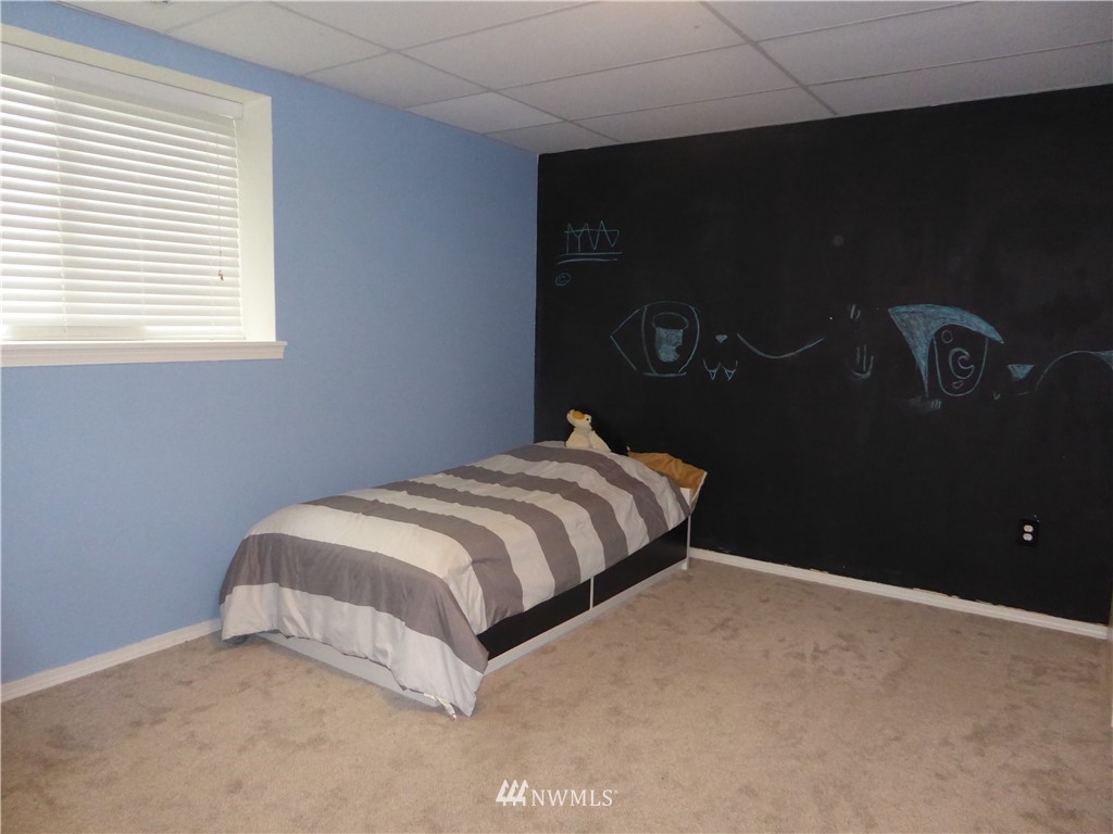 9024 176th Avenue Southwest Rochester, WA 98579 - Photo 15 of 25 a bedroom with a bed and a window