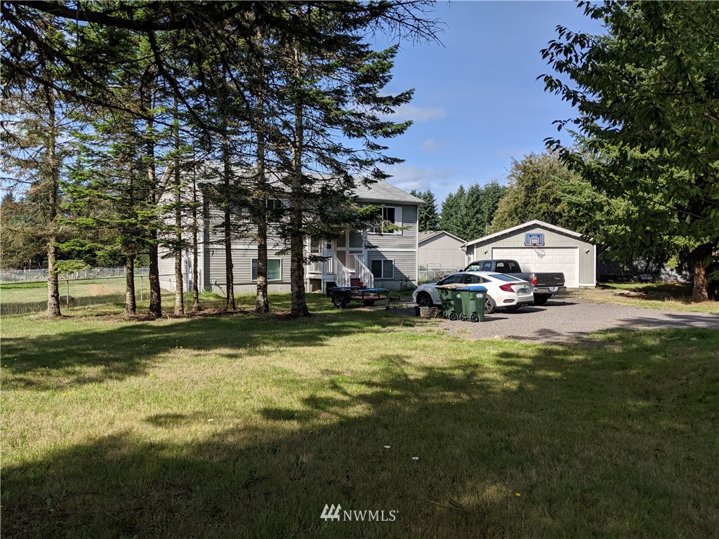 9024 176th Avenue Southwest Rochester, WA 98579 - Photo 23 of 25 a car parked in front of a house with a big yard