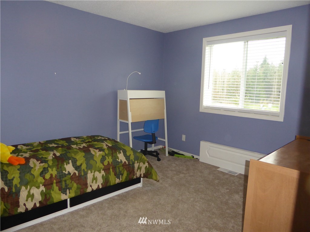 9024 176th Avenue Southwest Rochester, WA 98579 - Photo 9 of 25 a bedroom with a bed and a window