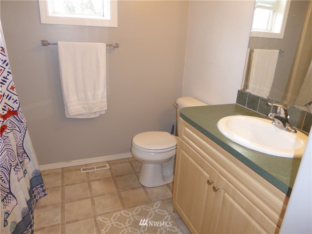 9024 176th Avenue Southwest Rochester, WA 98579 - Photo 10 of 25 a bathroom with a sink toilet and a mirror