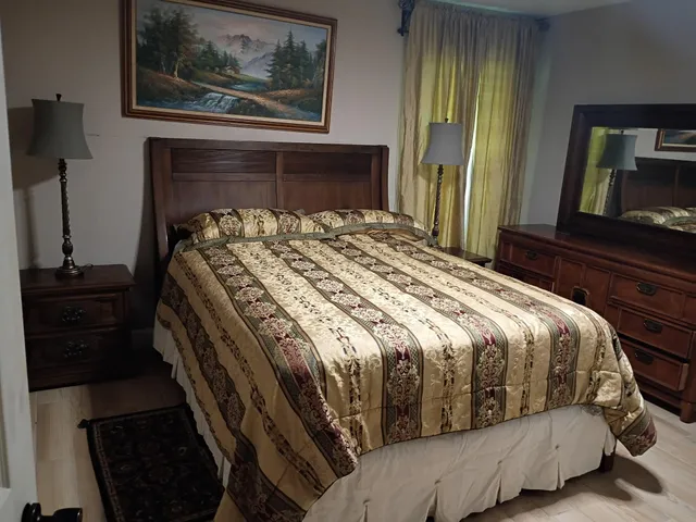 a bedroom with a bed and a dresser