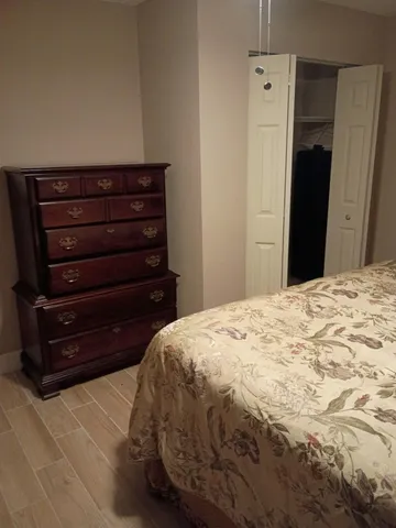 a bedroom with a bed and a dresser
