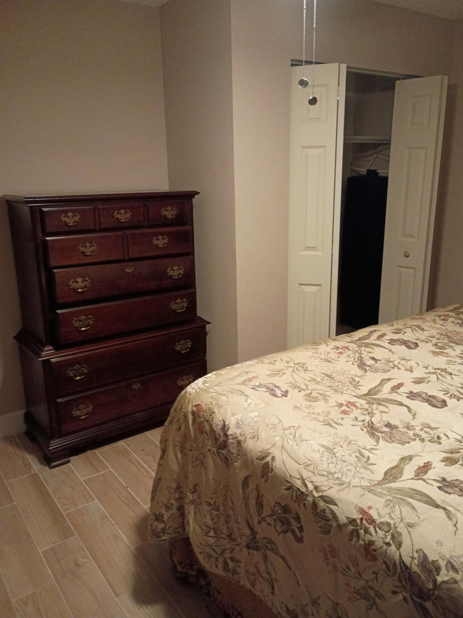 116 Southwest Ridgecrest Drive, Unit A Port St. Lucie, FL 34953 - Photo 3 of 8 a bedroom with a bed and a dresser