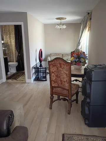 a dining room with furniture and a chandelier