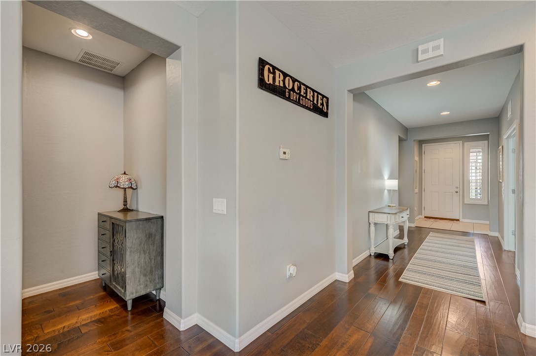 7049 Motley Road Las Vegas, NV 89178 - Photo 35 of 61 Rich wood flooring runs throughout the welcoming entry hall with recessed lighting.