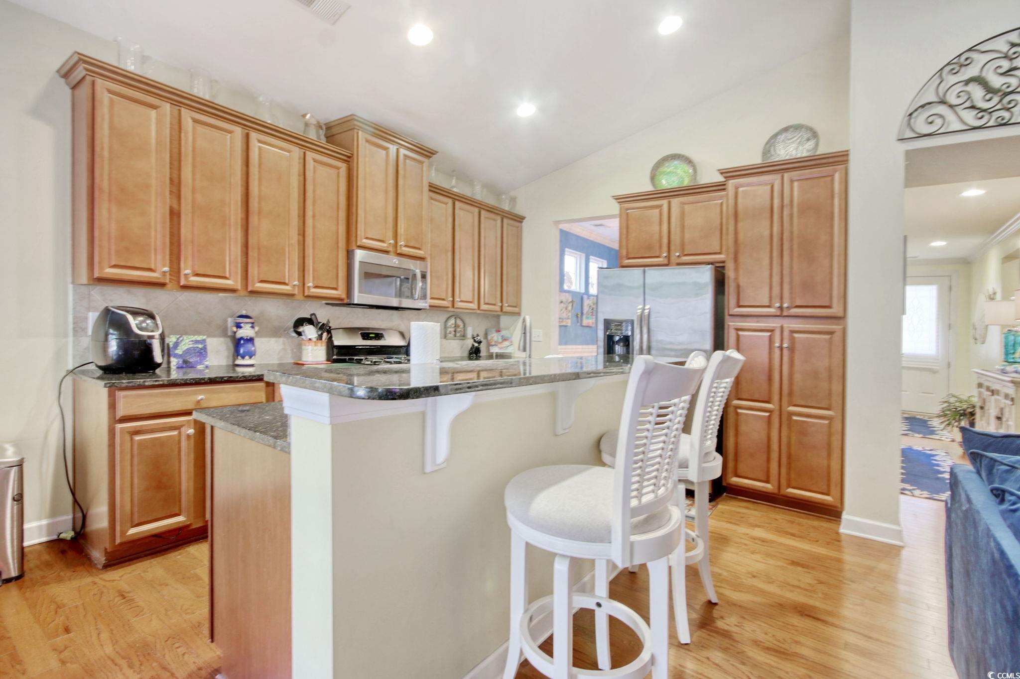 1878 Heritage Loop Myrtle Beach, SC 29577 - Photo 15 of 40 Kitchen featuring light wood-style flooring, a bre