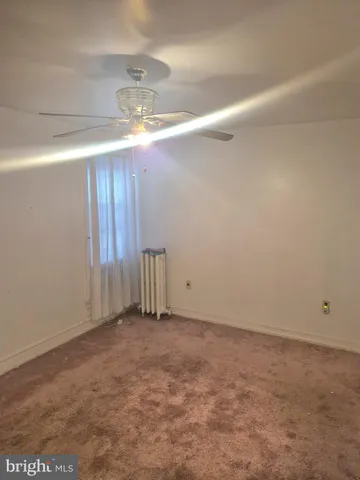 a view of a storage & utility room with closet window