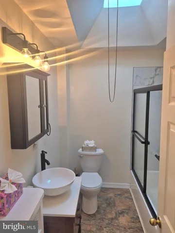 a bathroom with a sink mirror and vanity