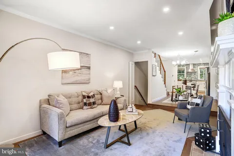 a view of a dining room with furniture and a kitchen