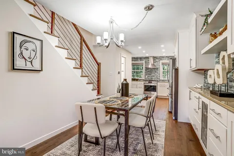 a kitchen with kitchen island wooden floor appliances and cabinets