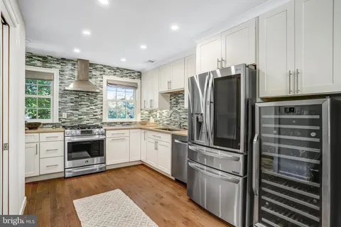 a kitchen with stainless steel appliances granite countertop a stove and a sink