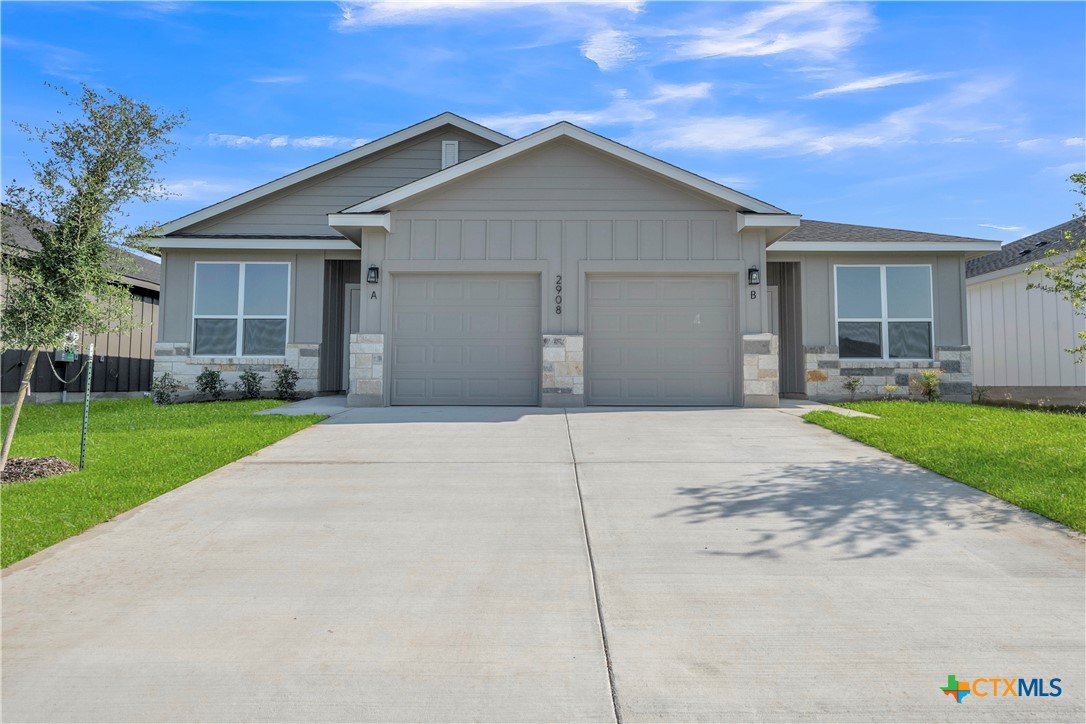2015 Bear Grass Rdg Road Temple, TX 76501 - Photo 1 of 17 a front view of a house with a yard and garage