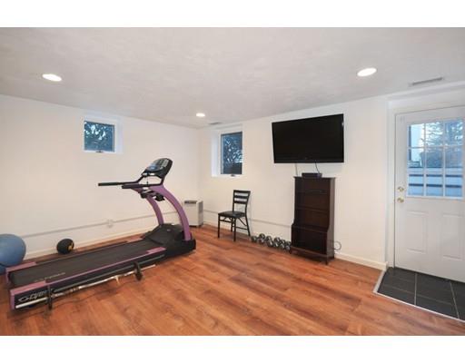 21 Sandy Pond Road Concord, MA 01742 - Photo 17 of 20 a living room with furniture and a flat screen tv
