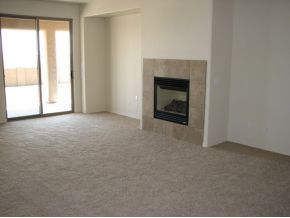 1185 Rusty Nail Road Prescott Valley, AZ 86314 - Photo 6 of 12 an empty room with windows and fireplace