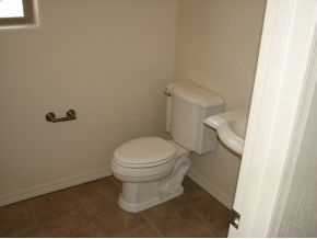 1185 Rusty Nail Road Prescott Valley, AZ 86314 - Photo 9 of 12 a white toilet sitting next to a white cabinet