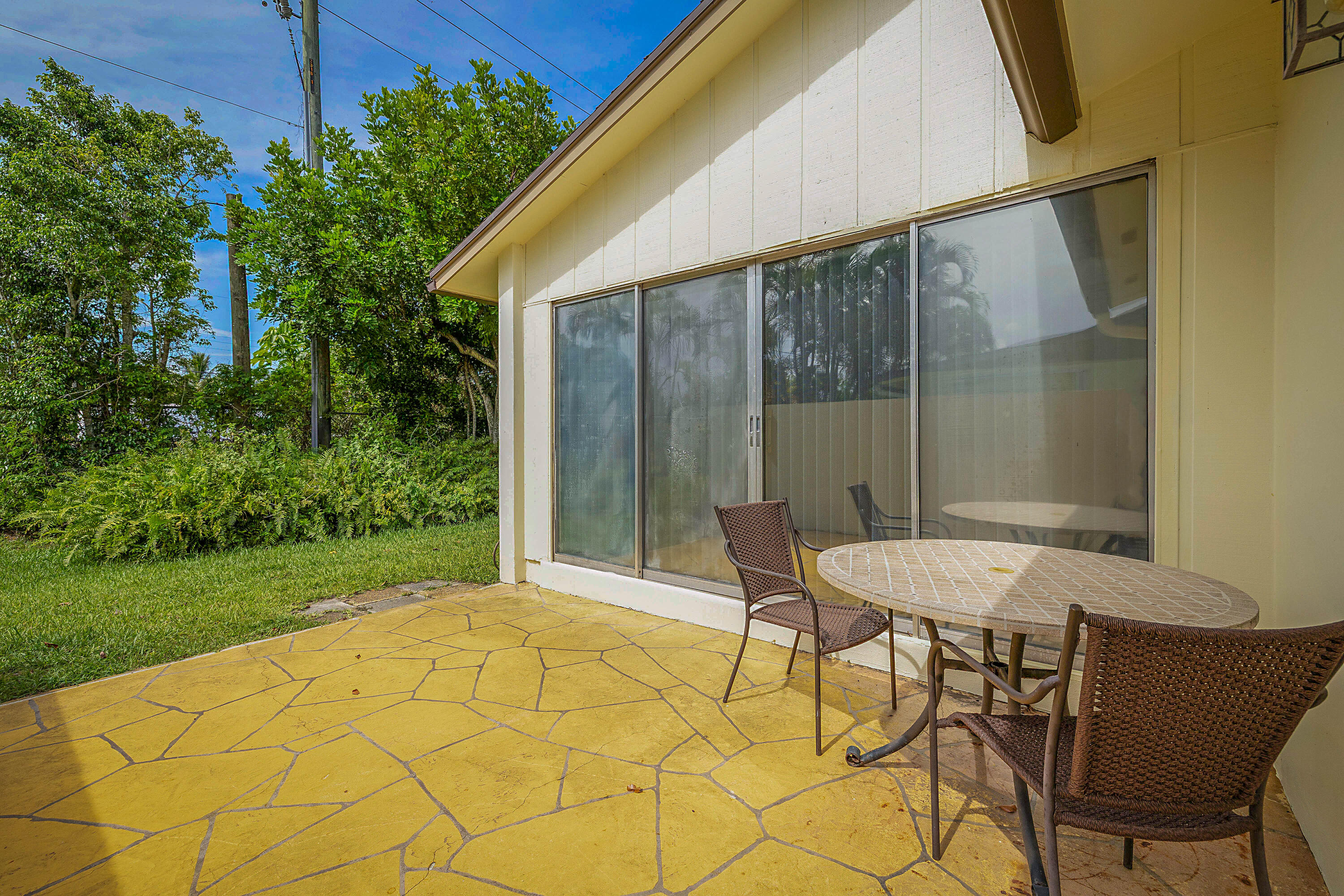 5231 Copperleaf Circle Delray Beach, FL 33484 - Photo 26 of 31 a backyard of a house with table and chairs