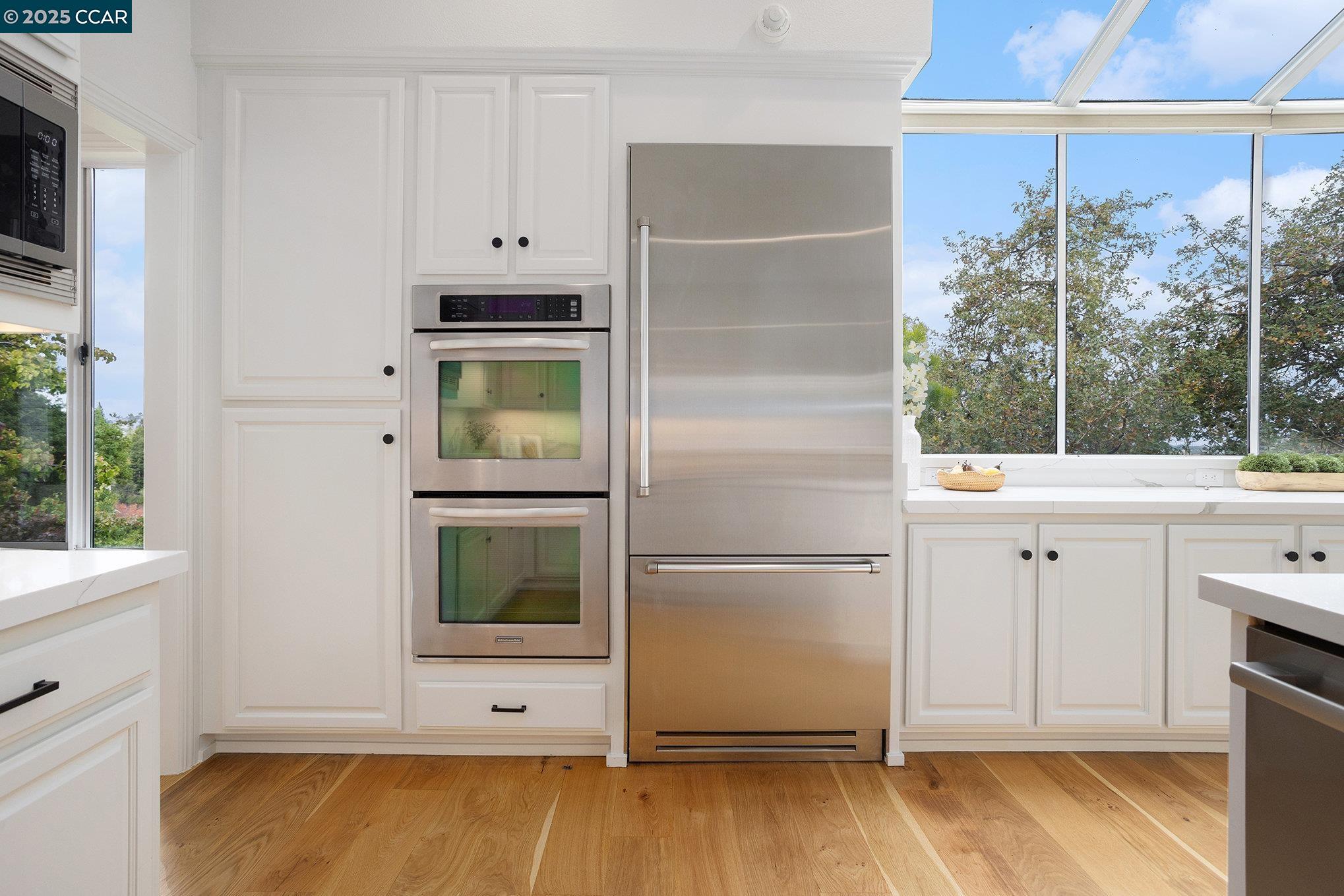 2199 Hidden Pond Road Lafayette, CA 94549 - Photo 11 of 40 a view of kitchen with wooden floor washer and dryer