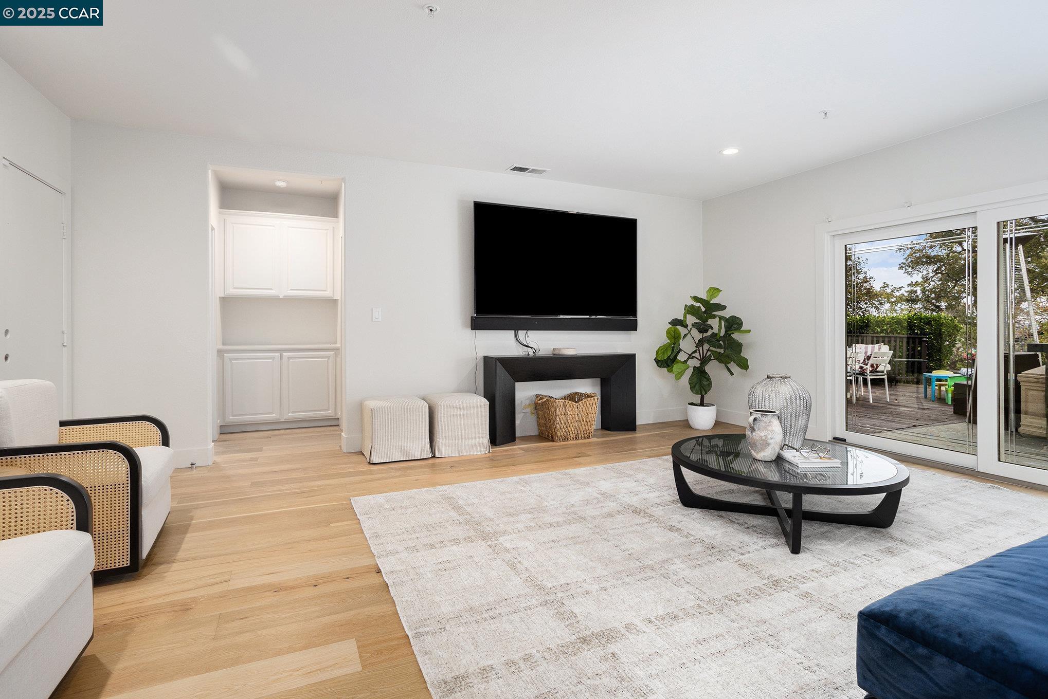 2199 Hidden Pond Road Lafayette, CA 94549 - Photo 22 of 40 a living room with furniture a flat screen tv and a fireplace