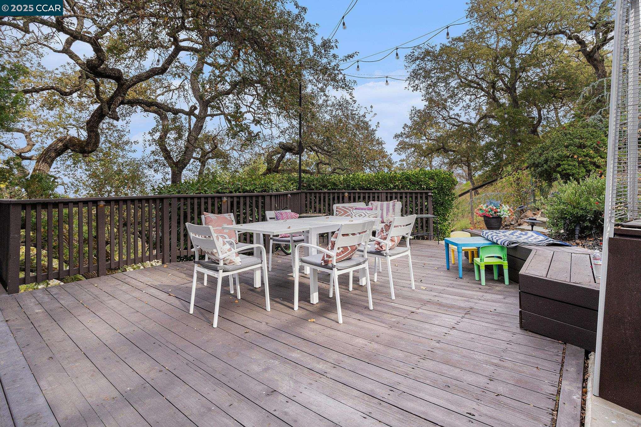 2199 Hidden Pond Road Lafayette, CA 94549 - Photo 32 of 40 a view of a deck with table and chairs a couches and wooden floor