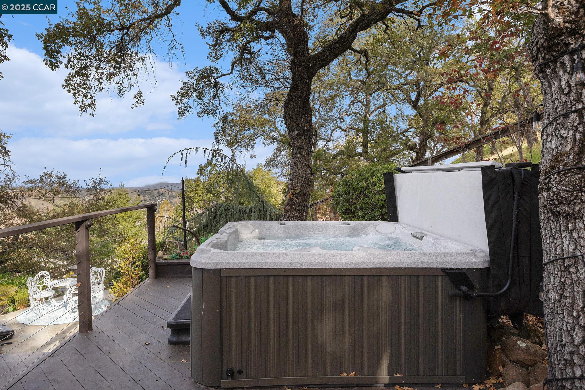 2199 Hidden Pond Road Lafayette, CA 94549 - Photo 38 of 40 a roof deck with table and chairs under an umbrella