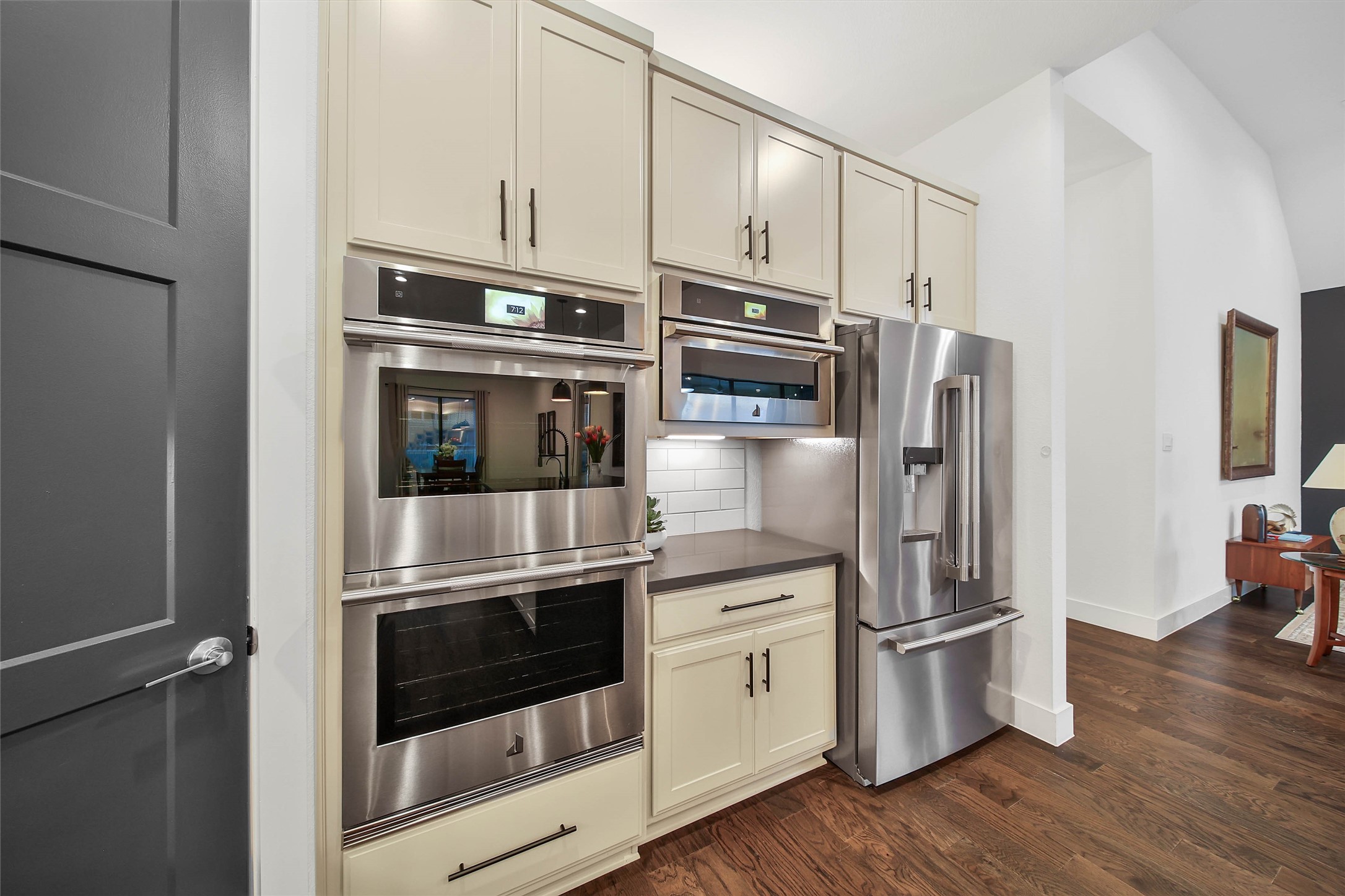 1015 Oak Briar Lane Conroe, TX 77384 - Photo 21 of 50 a kitchen with stainless steel appliances a refrigerator stove and wooden floor