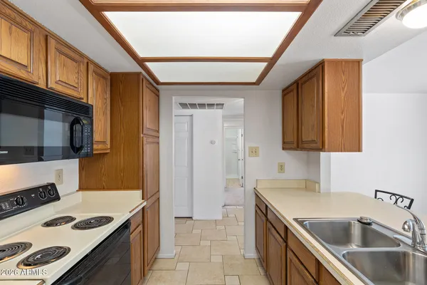 a kitchen with a stove and a refrigerator