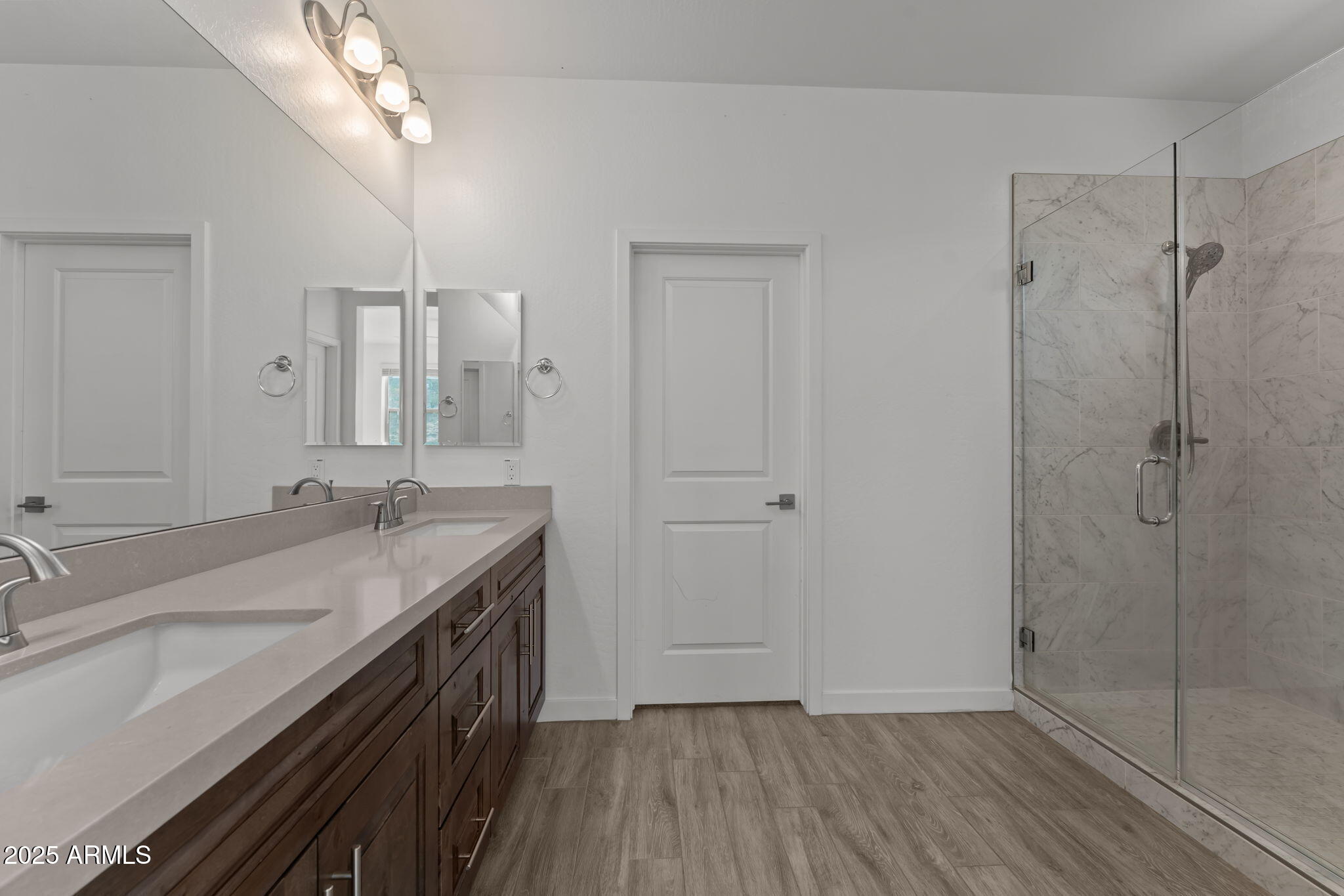 1985 West Ringo Road Wickenburg, AZ 85390 - Photo 13 of 25 a bathroom with a granite countertop sink a mirror and shower