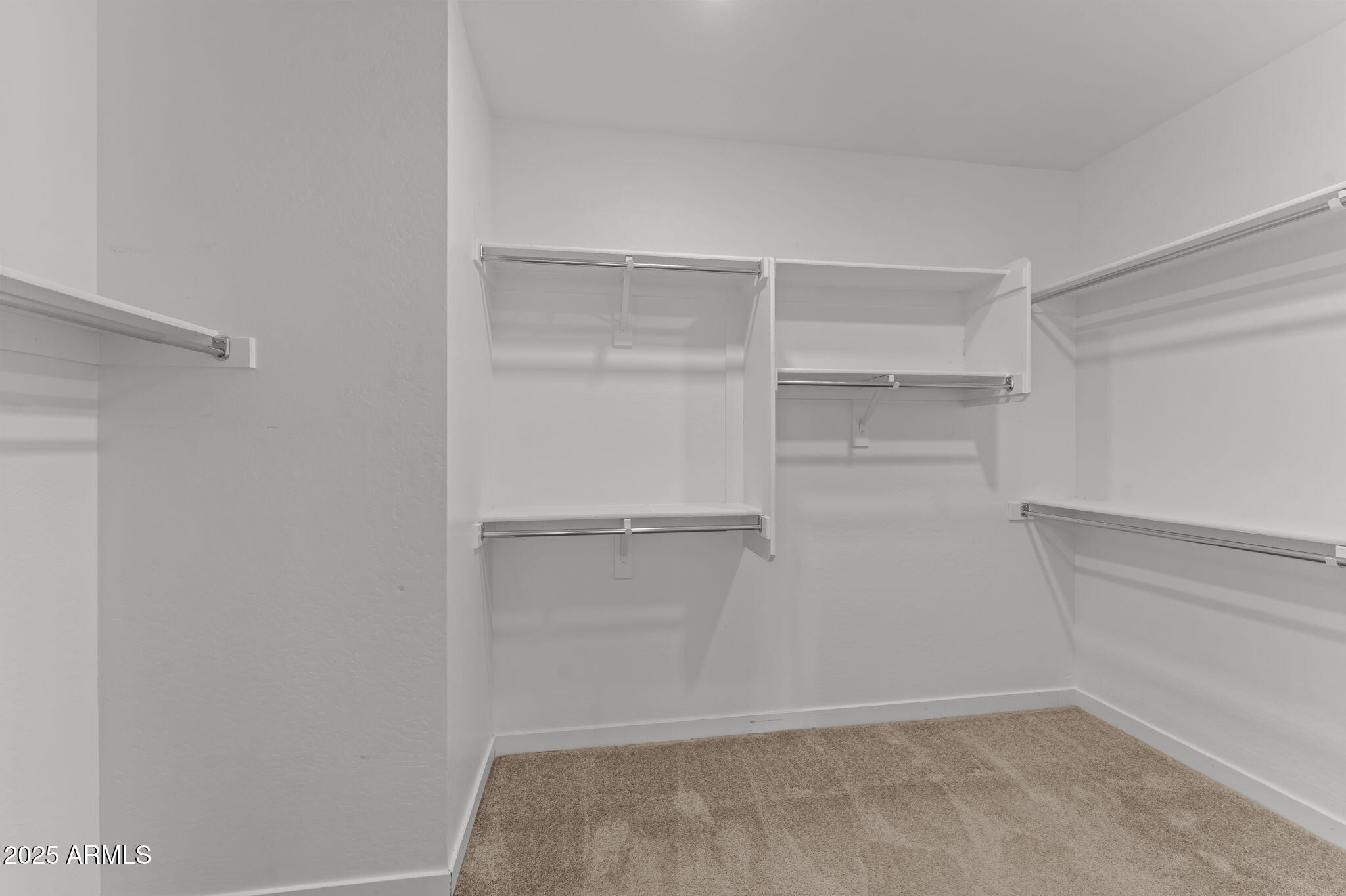 1985 West Ringo Road Wickenburg, AZ 85390 - Photo 16 of 25 a view of walk in closet with empty racks