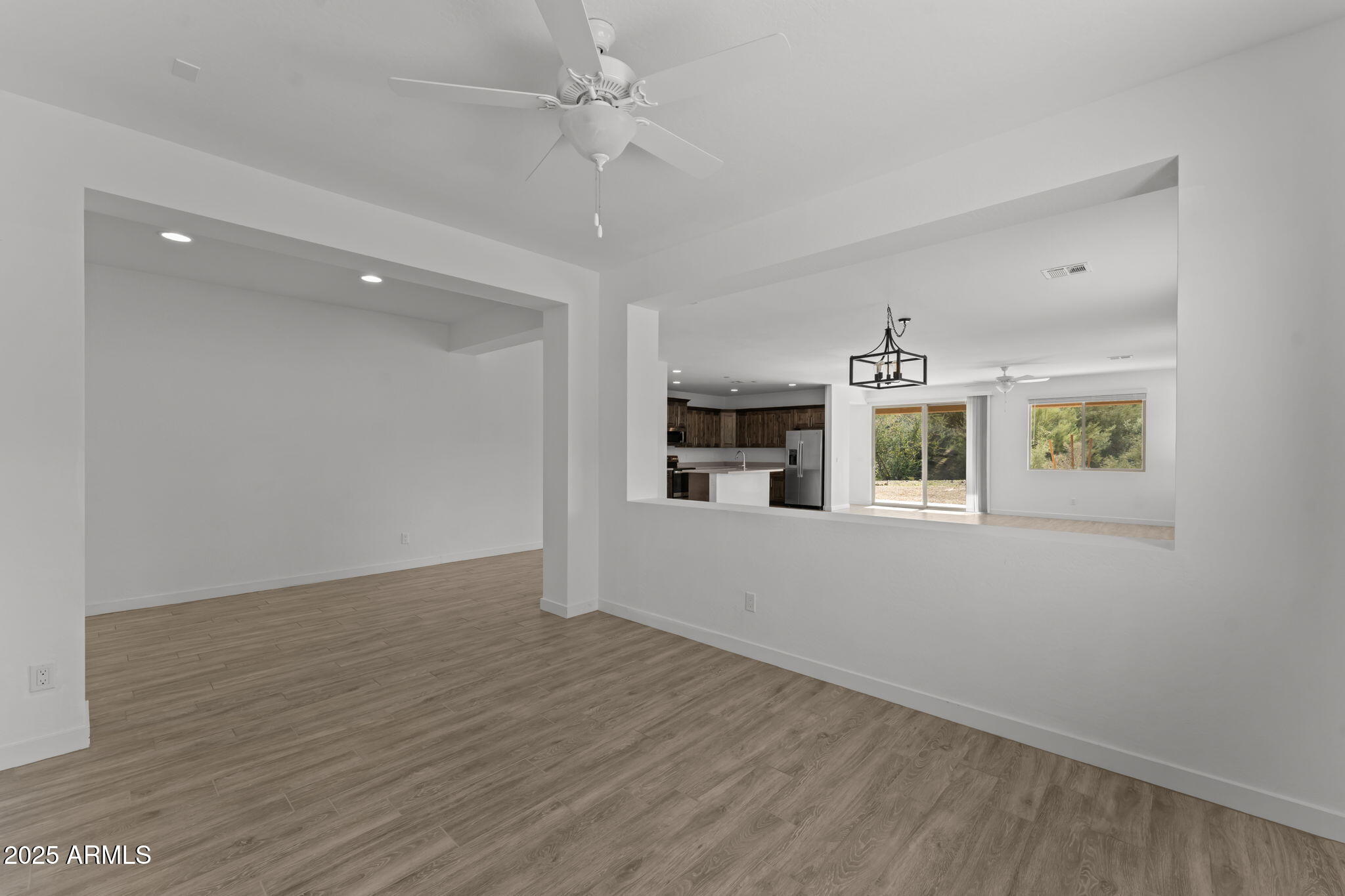 1985 West Ringo Road Wickenburg, AZ 85390 - Photo 10 of 25 wooden floor in an empty room with a window