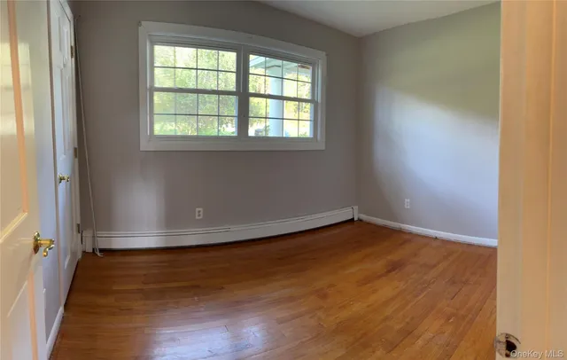 a view of a room with wooden floor and windows