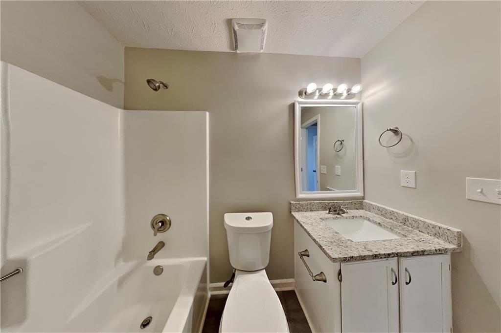2705 Braemore Place Powder Springs, GA 30127 - Photo 14 of 18 a bathroom with a granite countertop sink and a mirror