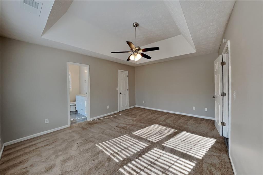 2705 Braemore Place Powder Springs, GA 30127 - Photo 6 of 18 a view of a room with a ceiling fan and wooden floor