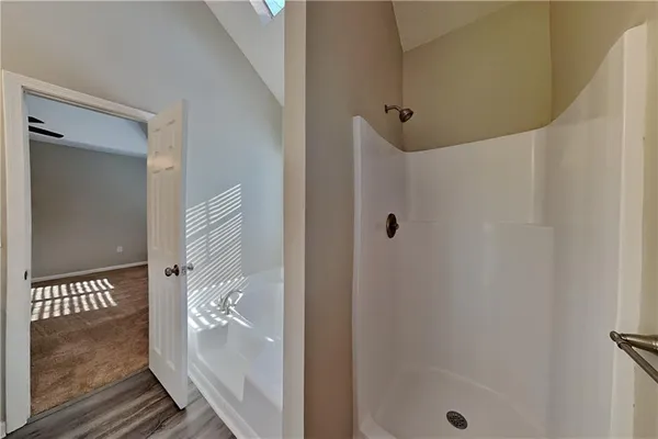 a bathroom with a glass shower door