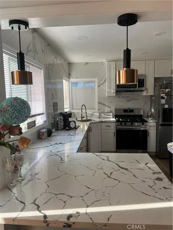 a kitchen with stainless steel appliances granite countertop a sink counter space and cabinets