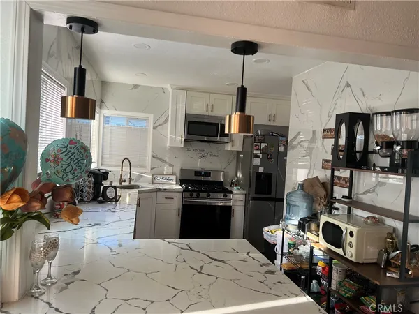 a kitchen with sink cabinets and appliances