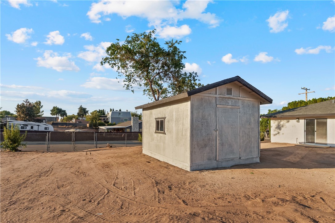 7046 Seventh Avenue Hesperia, CA 92345 - Photo 37 of 46 a view of house with backyard and trees in the background