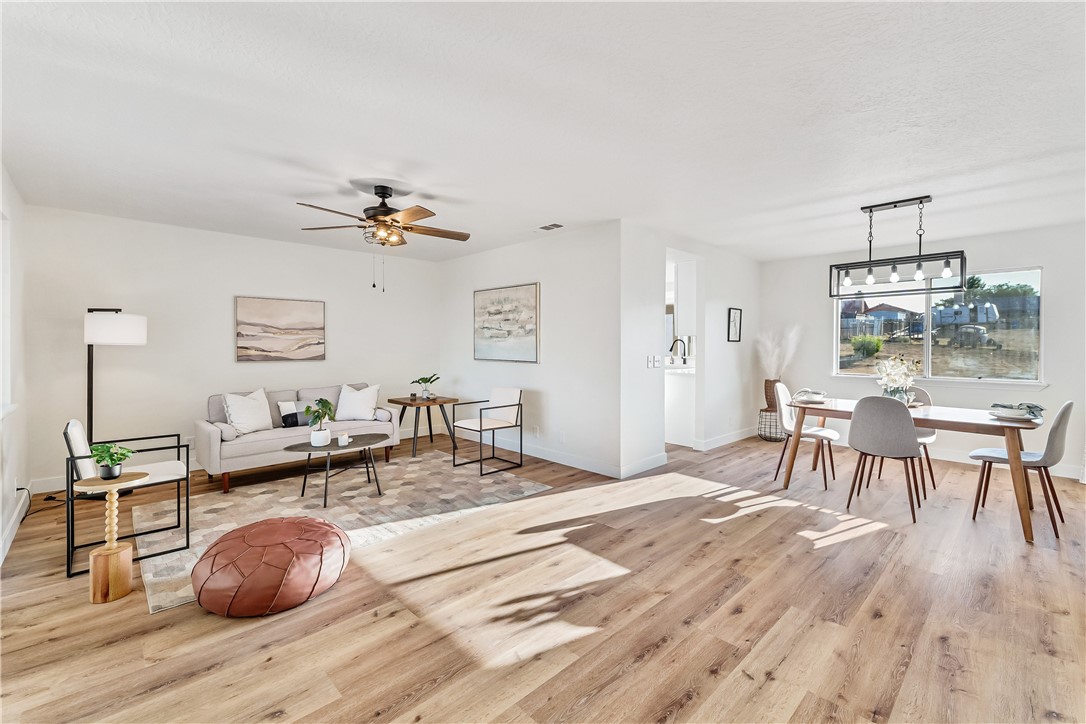 7046 Seventh Avenue Hesperia, CA 92345 - Photo 10 of 46 a living room with furniture and a wooden floor