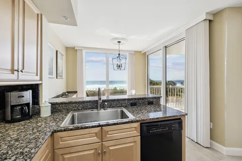 a kitchen with granite countertop a sink and a window