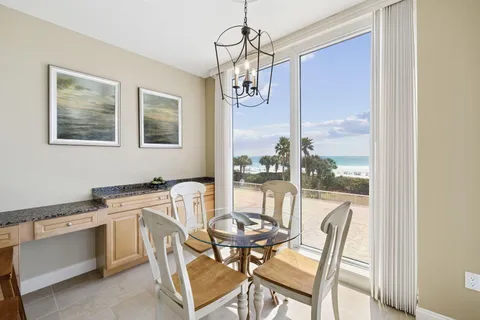 a view of a dining room with furniture wooden floor and a chandelier