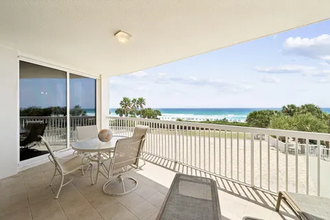 a view of a chairs and table in patio