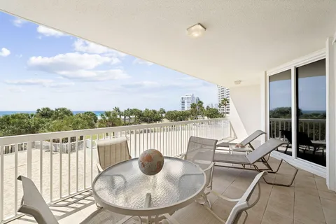 a view of a balcony with table and chairs