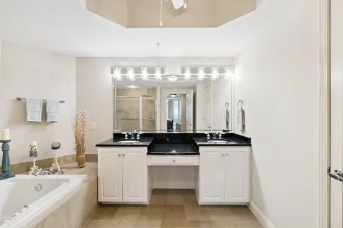 a view of a double vanity sink mirror and window