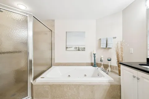 a bathroom with a bathtub and a shower
