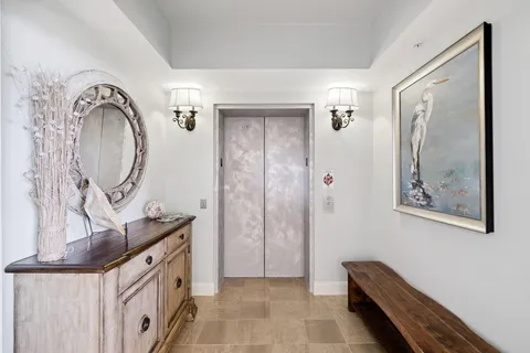 a spacious bathroom with a mirror a double vanity sink and glass door