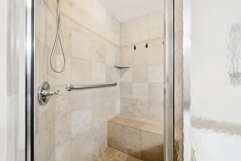 a bathroom with a glass shower door